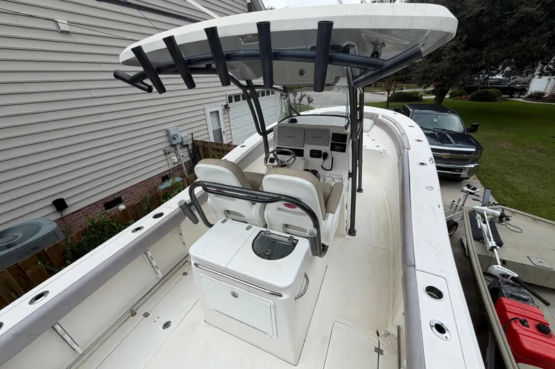 Slide: The Image of 2015 Sea Fox 286 Commander boat with dual seats and control panel, parked outdoors. - 26