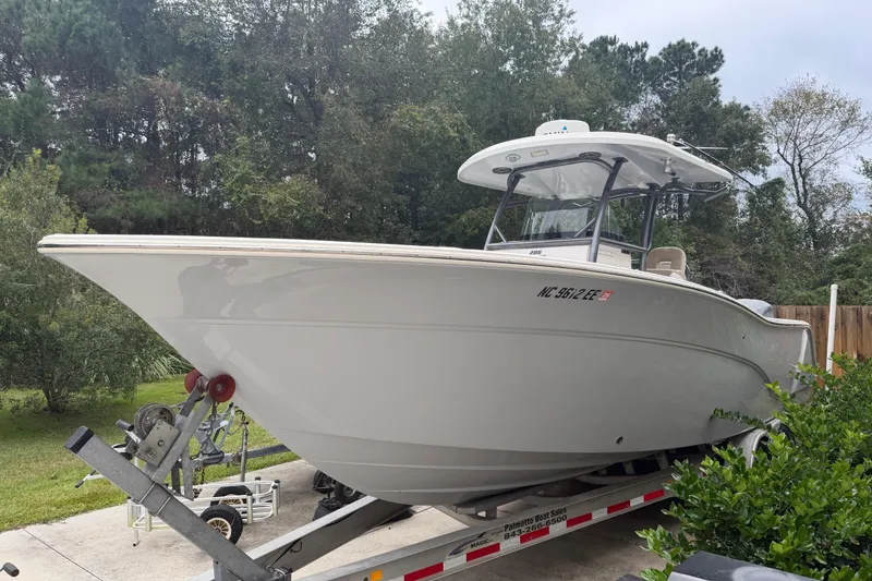 Slide: The Image of 2015 Sea Fox 286 Commander boat on trailer, surrounded by trees. - 3