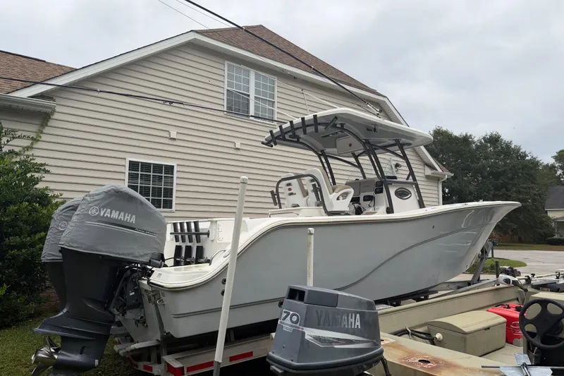 Slide: The Image of 2015 Sea Fox 286 Commander boat with Yamaha engine, parked near a house. - 5