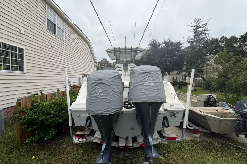 Slide: The Image of 2015 Sea Fox 286 Commander boat with Yamaha engines, parked beside a house. - 6