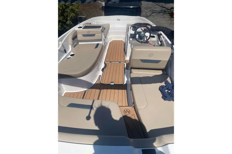 Slide: The Image of 2023 Hurricane SunDeck Sport 185 OB boat interior with beige seating and wood-style flooring. - 5