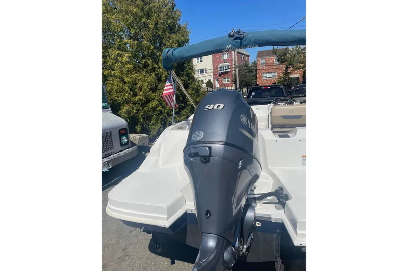 Slide: The Image of 2023 Hurricane SunDeck Sport 185 OB boat with Yamaha 90 engine, parked outdoors. - 6