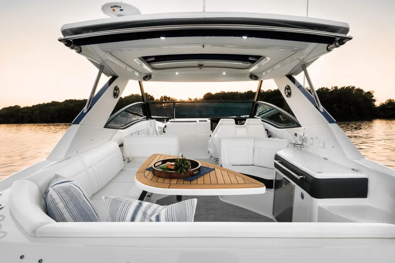 Slide: The Image of Interior of Sea Ray Sundancer 320 yacht, 2026 model, at sunset. - 12