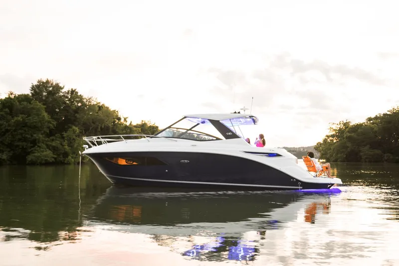 Slide: The Image of Sea Ray Sundancer 320 yacht on calm water, year 2026. - 2