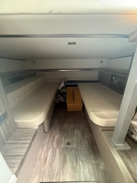 Slide: The Image of Interior of a Sea Ray Sundancer 320 with two cushioned benches and wooden flooring. - 15