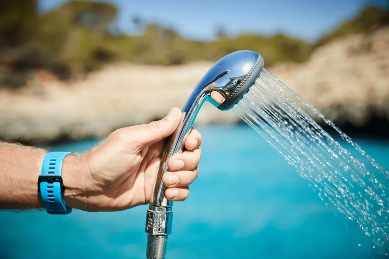 Slide: The Image of Hand holding showerhead on Sea Ray Sundancer 320, 2026. - 41
