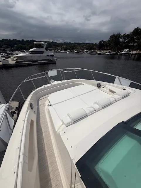 Slide: The Image of The image shows the foredeck of a 2026 Sea Ray Sundancer 320 docked in a marina. - 16