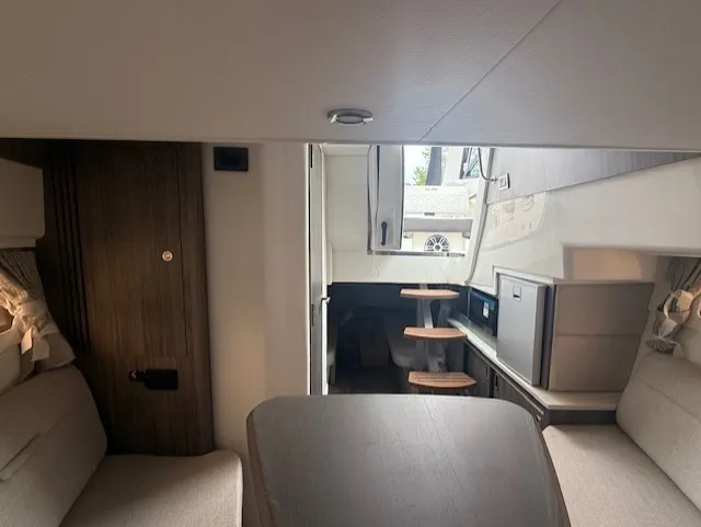 Slide: The Image of Interior of the 2026 Sea Ray Sundancer 320 with modern furnishings and cozy seating. - 13
