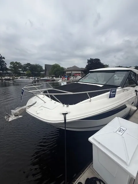Slide: The Image of A 2026 Sea Ray Sundancer 320 docked. It features a sleek, modern design. - 18
