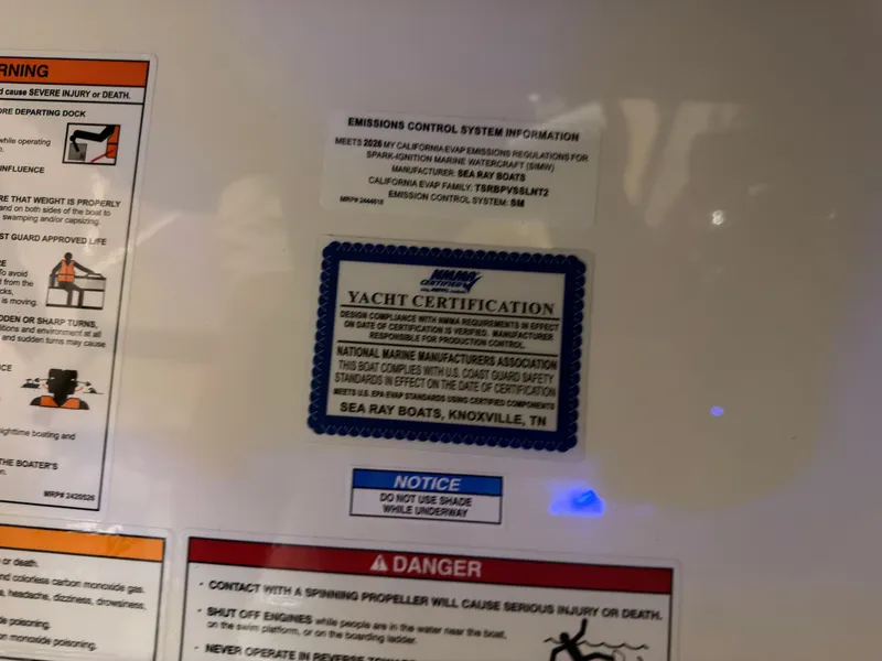 Slide: The Image of Certification and warning labels on a boat, including emissions control system and safety information. - 45
