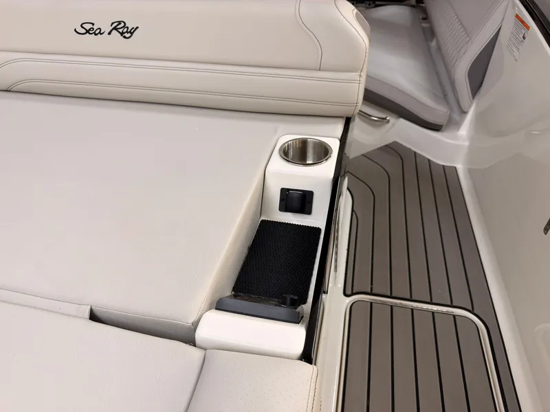 Slide: The Image of The image shows the sleek cockpit of a Sea Ray SLX 280 with beige upholstery and a cup holder. - 15