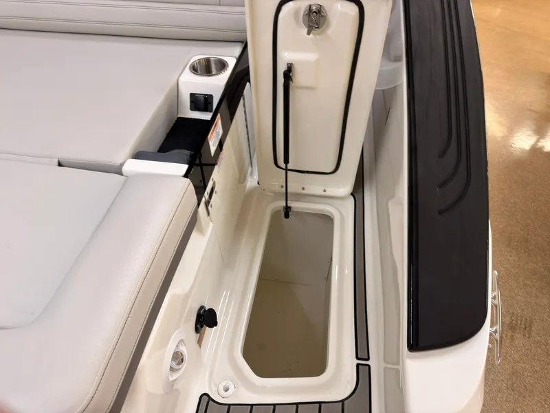 Slide: The Image of The image shows the storage area of a 2026 Sea Ray SLX 280 boat with cushioned seating. - 12
