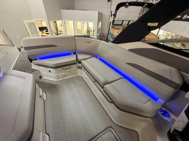 Slide: The Image of The image shows the interior of a Sea Ray SLX 280 boat with sleek seating and blue lighting. - 17