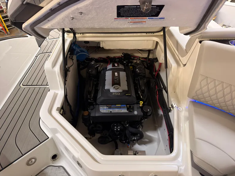 Slide: The Image of The engine compartment of a 2026 Sea Ray SLX 280 shows a neatly installed engine with wires and hoses. - 19