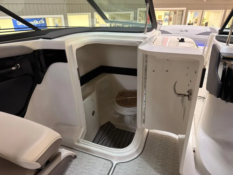 Slide: The Image of The image shows the interior of a 2026 Sea Ray SLX 280 with a small toilet area. - 35