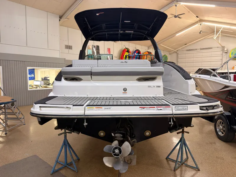 Slide: The Image of The image shows the rear of a 2026 Sea Ray SLX 280 boat in a showroom. - 4