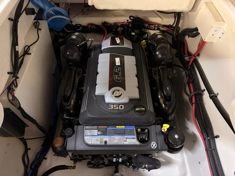 Slide: The Image of A powerful engine inside a boat, surrounded by cables and hoses. - 20