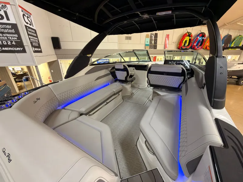 Slide: The Image of The image shows the interior of a 2026 Sea Ray SLX 280 boat with sleek seating and blue lighting. - 16
