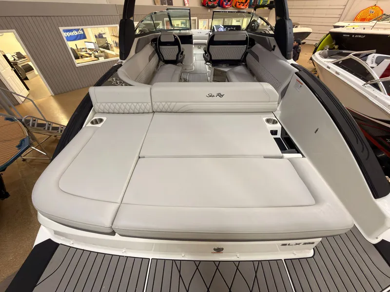 Slide: The Image of The image shows the spacious aft deck of a 2026 Sea Ray SLX 280 boat with sleek white upholstery. - 7
