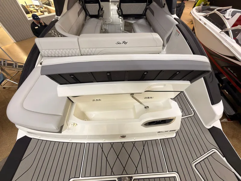 Slide: The Image of The image shows the stern of a 2026 Sea Ray SLX 280 with gray upholstery and storage. - 10