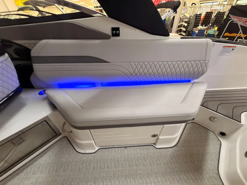 Slide: The Image of The 2026 Sea Ray SLX 280 interior features elegant upholstery and blue LED lighting. - 26