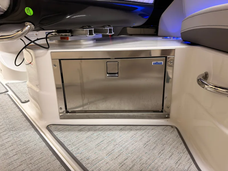 Slide: The Image of The interior of a 2026 Sea Ray SLX 280 features a stainless steel refrigerator and cushioned seating. - 28
