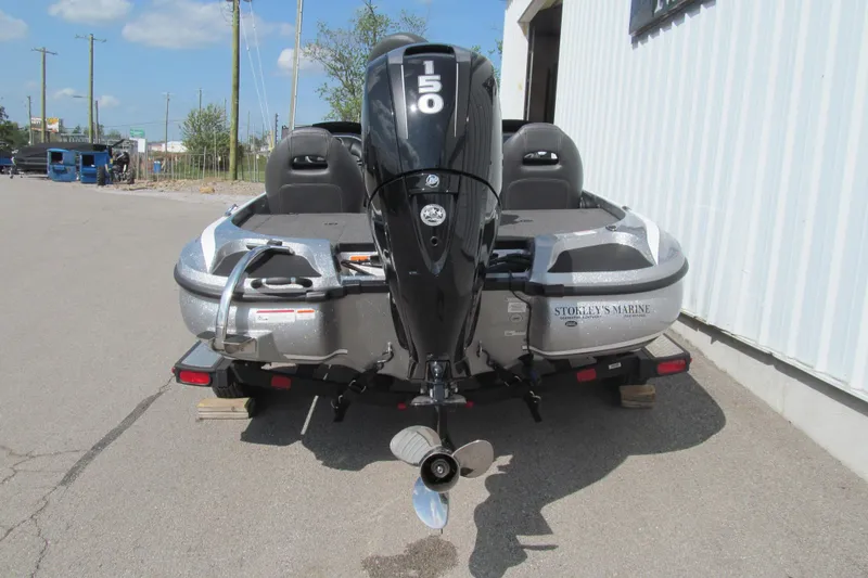 Slide: The Image of 2017 Nitro Z18 boat with 150 HP engine parked outside a building. - 4