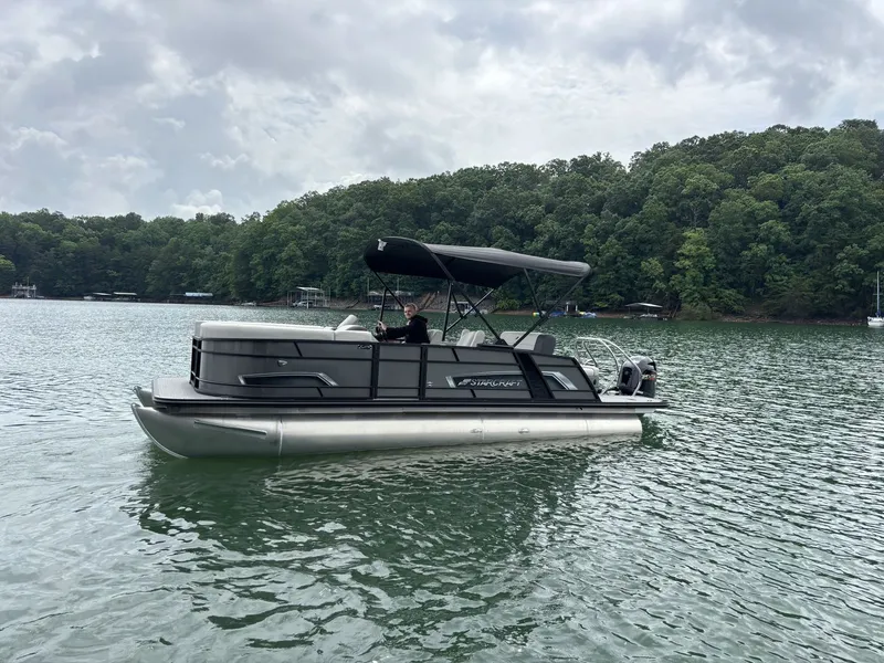Slide: The Image of Starcraft EXS 3 Q DH 2025 pontoon boat on a serene lake. - 0