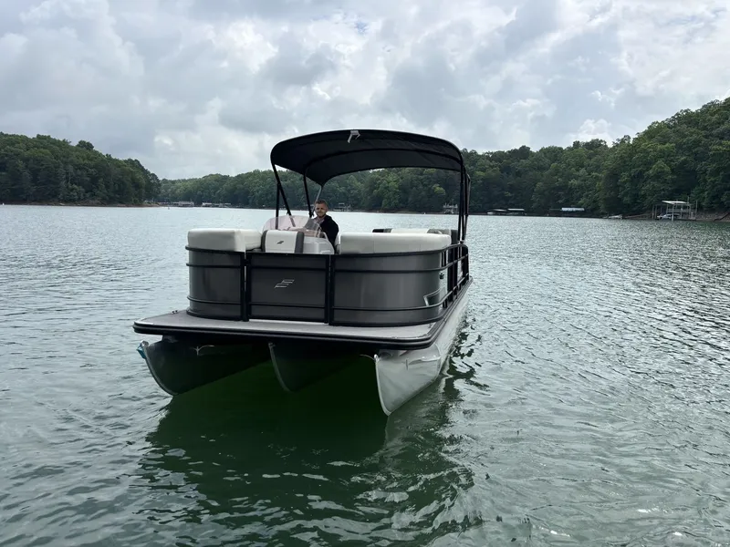 Slide: The Image of Starcraft EXS 3 Q DH 2025 pontoon boat on a serene lake. - 1