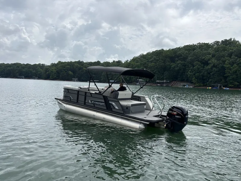 Slide: The Image of Starcraft EXS 3 Q DH 2025 pontoon boat on a calm lake. - 14