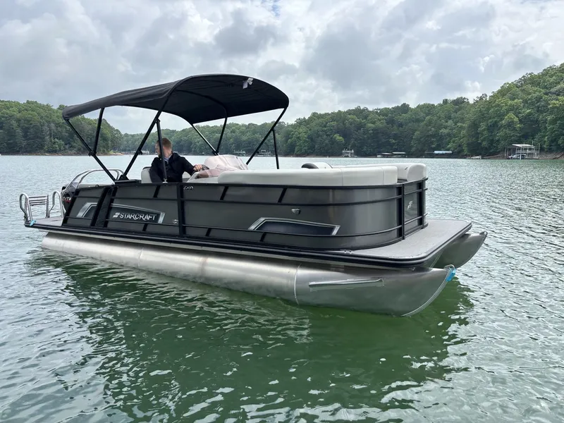 Slide: The Image of Starcraft EXS 3 Q DH 2025 pontoon boat on a lake. - 3
