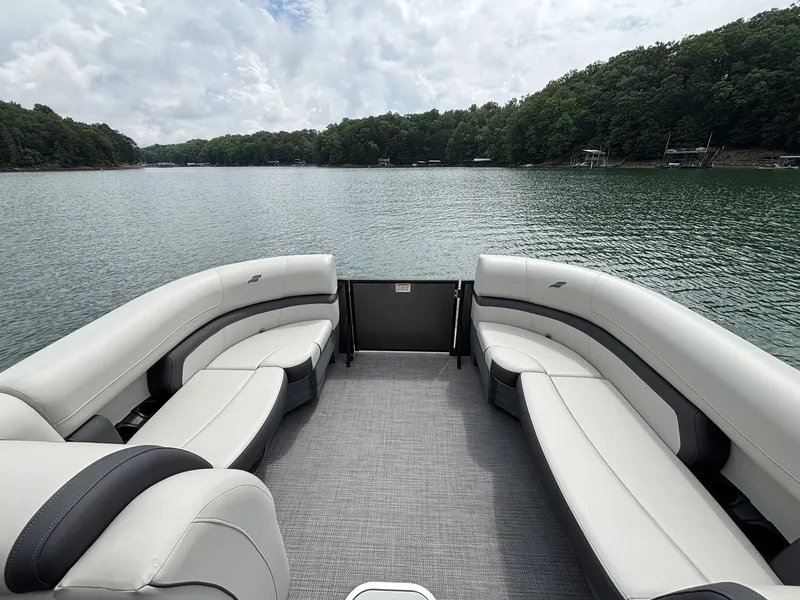 Slide: The Image of Starcraft EXS 3 Q DH 2025 pontoon boat on a serene lake. - 4