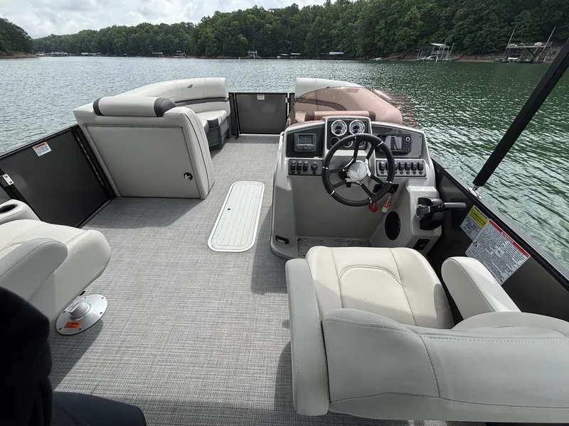 Slide: The Image of Interior of 2025 Starcraft EXS 3 Q DH pontoon boat on a lake. - 6