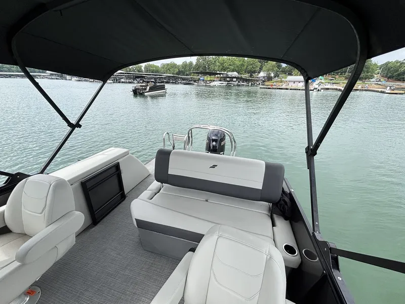 Slide: The Image of Interior view of Starcraft EXS 3 Q DH boat, 2025 model, on a calm lake. - 9