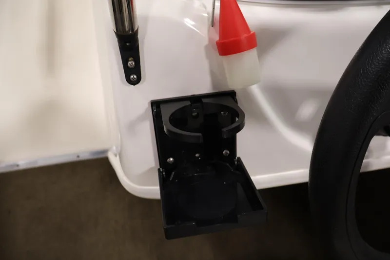 Slide: The Image of 2019 Bayliner 160 Bowrider cup holder and steering wheel detail. - 18