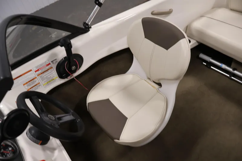 Slide: The Image of 2019 Bayliner 160 Bowrider interior with steering wheel and cushioned seat. - 19
