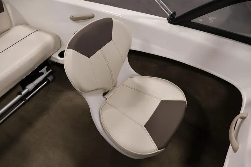Slide: The Image of 2019 Bayliner 160 Bowrider interior with beige and brown seating. - 20