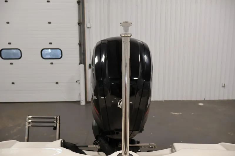Slide: The Image of 2019 Bayliner 160 Bowrider boat engine in a garage setting. - 24