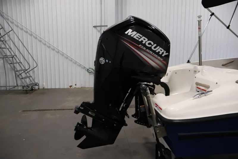 Slide: The Image of 2019 Bayliner 160 Bowrider with Mercury FourStroke outboard motor in a garage setting. - 27