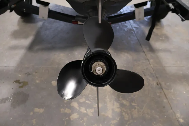 Slide: The Image of 2019 Bayliner 160 Bowrider boat propeller on a trailer, close-up view. - 30