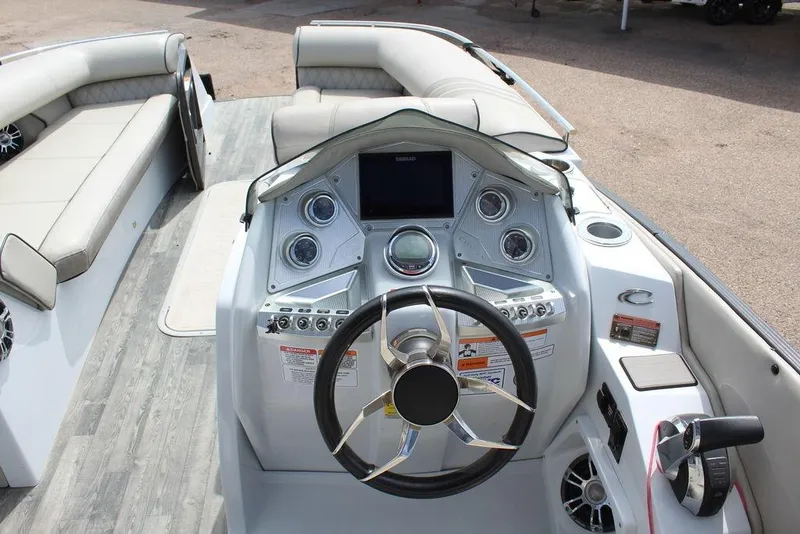 Slide: The Image of 2019 Crest Savannah 250 SLRC boat dashboard with steering wheel and control panel. - 15