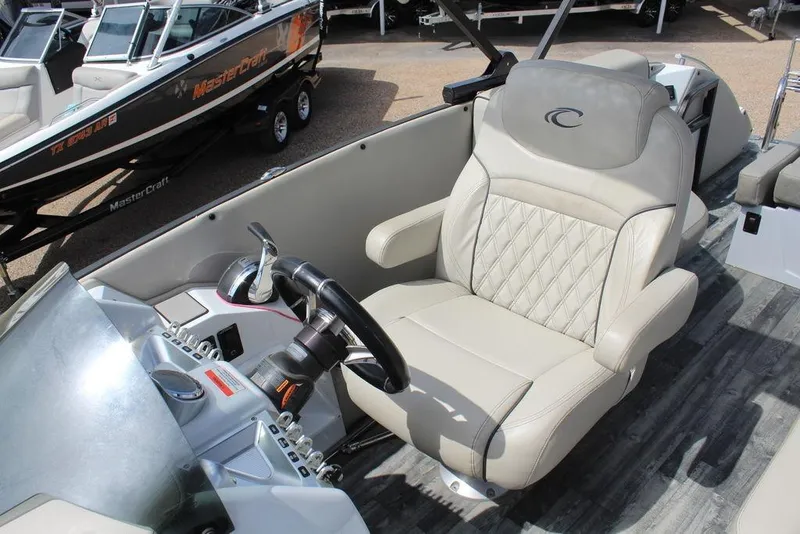 Slide: The Image of Captain's seat of 2019 Crest Savannah 250 SLRC boat with steering wheel and controls. - 18