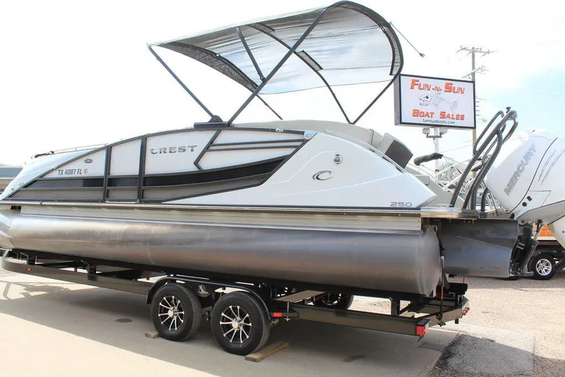 Slide: The Image of 2019 Crest Savannah 250 SLRC pontoon boat on trailer at dealership. - 9