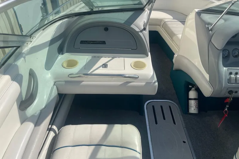 Slide: The Image of 1996 Sea Ray 210 Bow Rider interior with seating, dashboard, and storage compartments. - 10