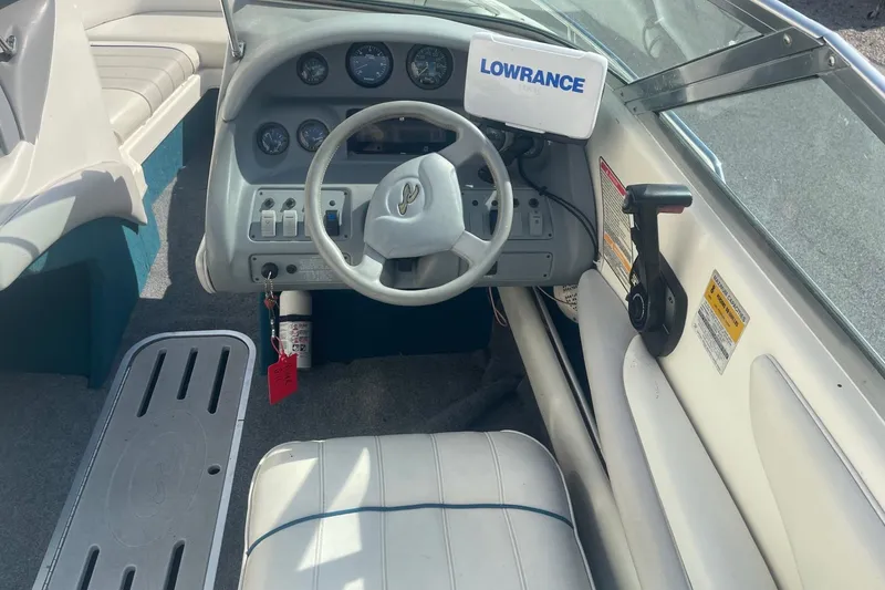 Slide: The Image of 1996 Sea Ray 210 Bow Rider dashboard with steering wheel and Lowrance device. - 12