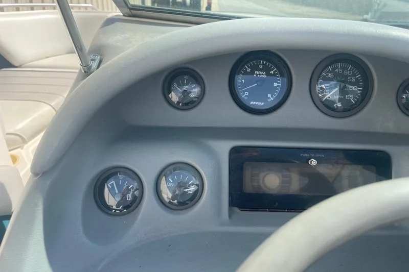 Slide: The Image of Dashboard of a 1996 Sea Ray 210 Bow Rider boat with gauges and controls. - 15