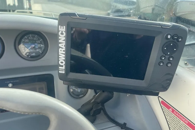 Slide: The Image of Lowrance fishfinder on 1996 Sea Ray 210 Bow Rider dashboard, with speedometer visible. - 16