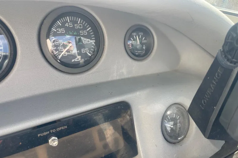 Slide: The Image of Dashboard of a 1996 Sea Ray 210 Bow Rider boat with gauges and controls. - 17