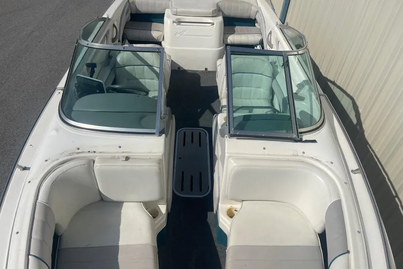 Slide: The Image of 1996 Sea Ray 210 Bow Rider boat interior with white seating and windshield. - 21