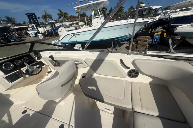 Slide: The Image of Interior view of a 2020 Sea Ray SPX 210 Outboard boat, showcasing seating and controls. - 11